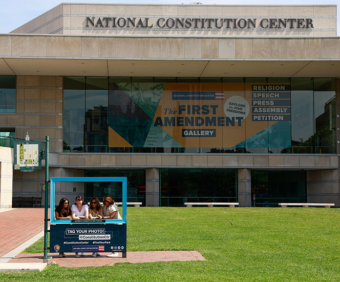 Photo of young women posing for a photo in front of the Constitution Center